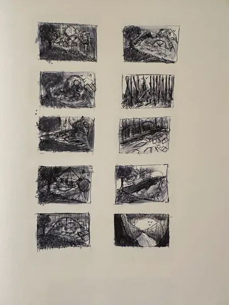 A sketchbook page gathers small studies of imagined characters, forms, and environments.